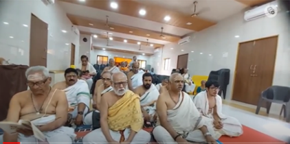 Devotees seated indoors